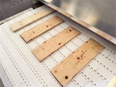 Microwave heating of wood products